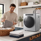 Silver compact tumble dryer on countertop with round door and side handle