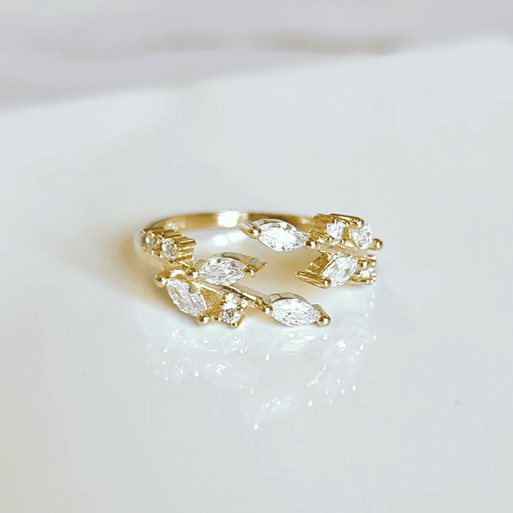 Gold-tone adjustable ring with marquise-cut clear stones, prong-set band