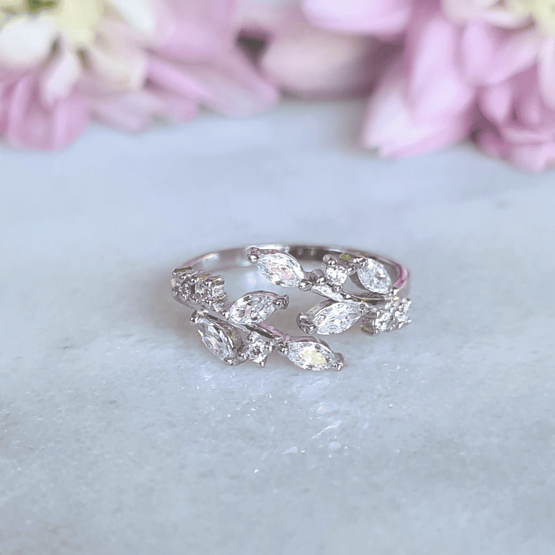 Adjustable sterling silver leaf ring with marquise-cut stones in open band
