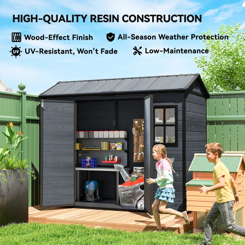 Dark grey resin garden storage shed with open double doors and interior shelves