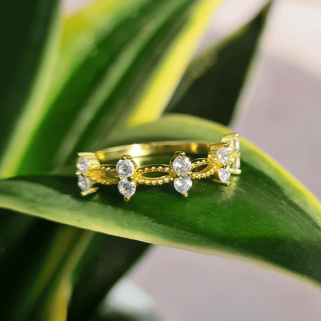 Gold crystal ring with marquise and round stones in a curved openwork design