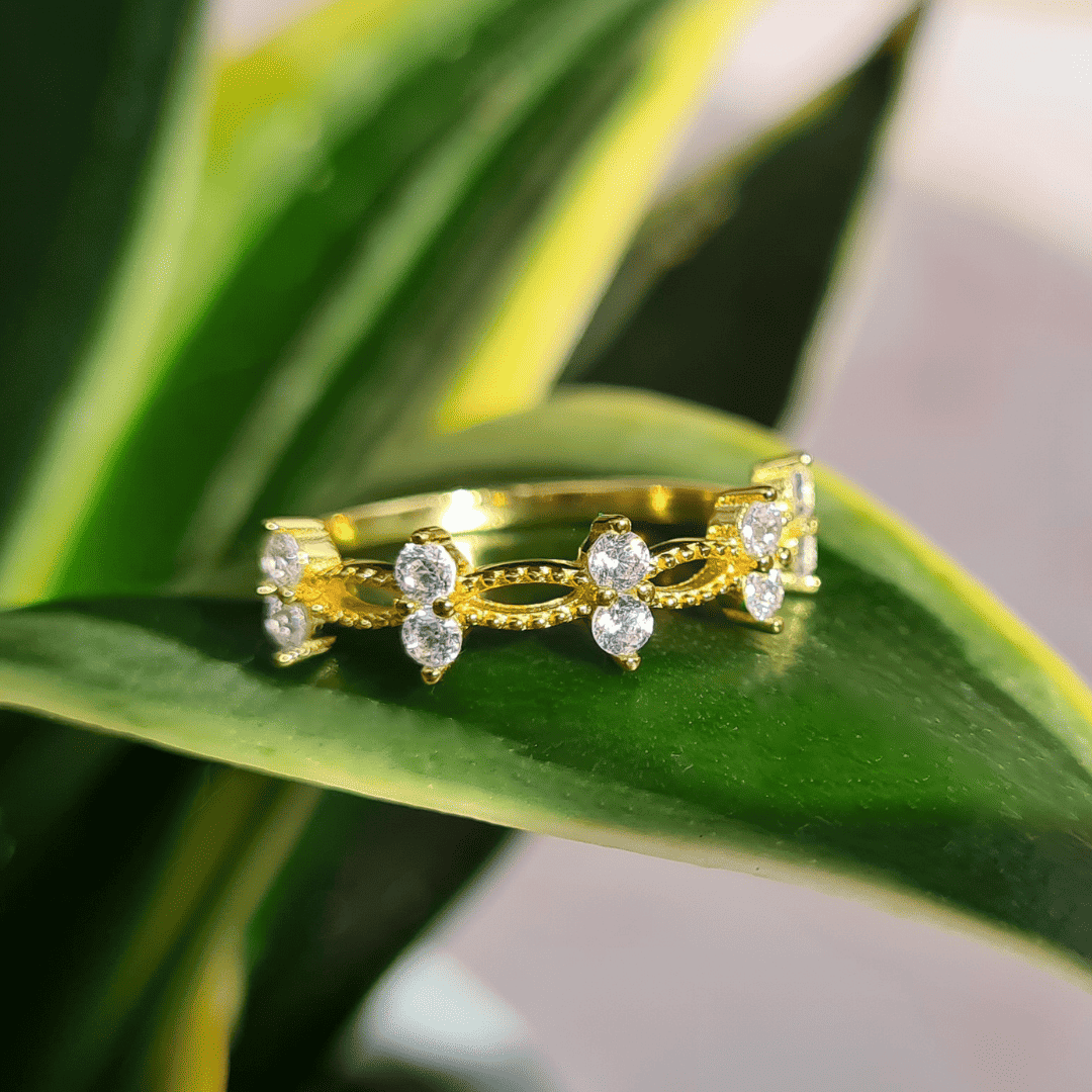 Gold crystal ring with marquise and round stones in a curved openwork design