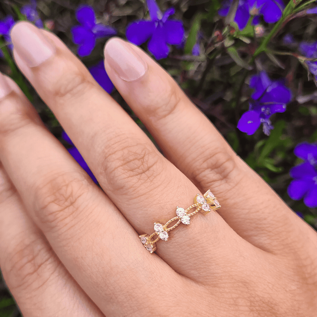 Gold crystal ring with stacked marquise stones and small round accents on finger