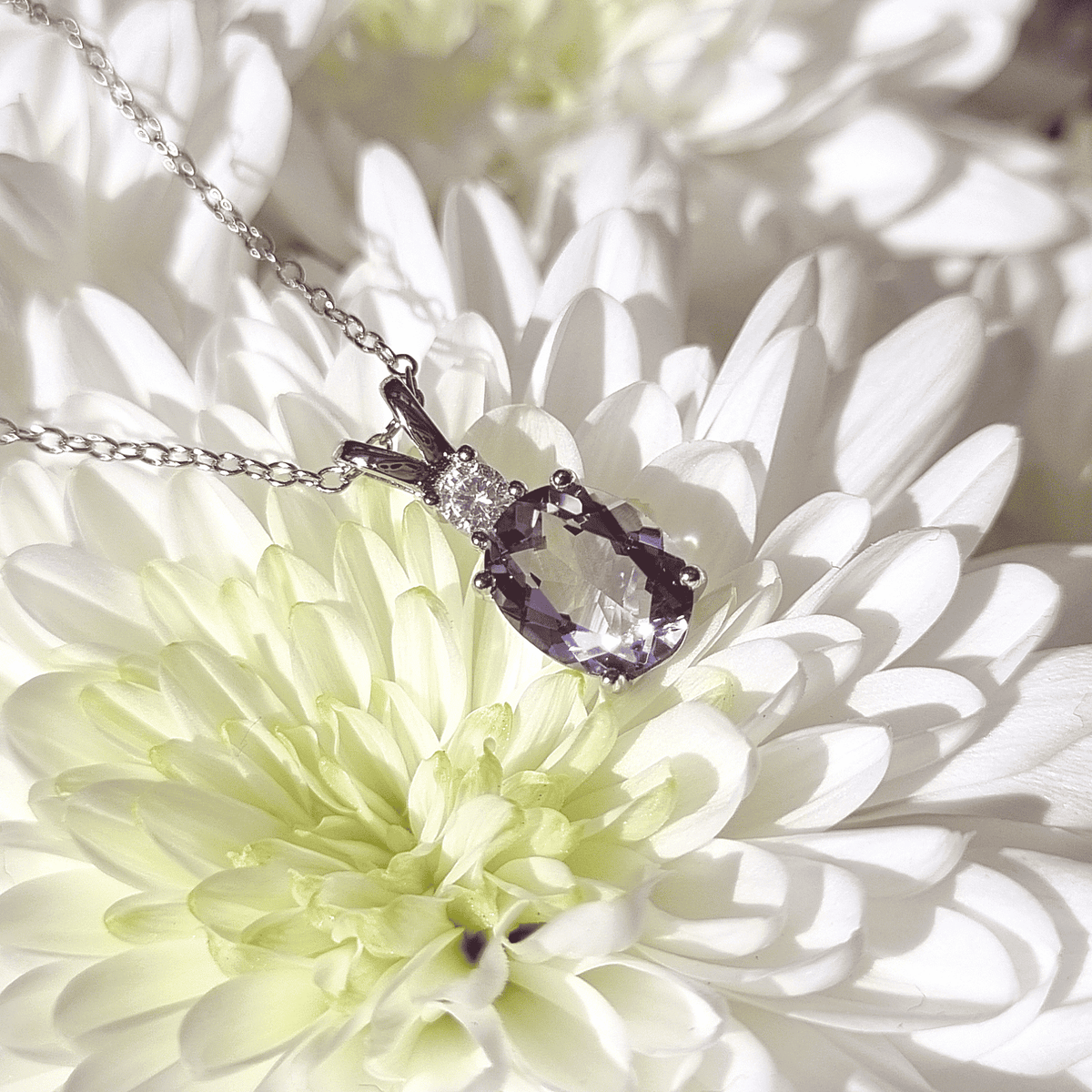 Sterling silver necklace with oval lavender amethyst pendant and sparkling side stones