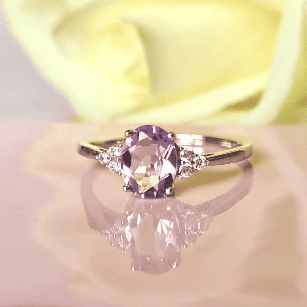 Sterling silver ring featuring a large oval lavender amethyst with diamond side stones