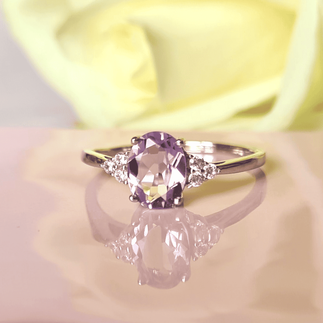 Sterling silver ring featuring a large oval lavender amethyst with diamond side stones