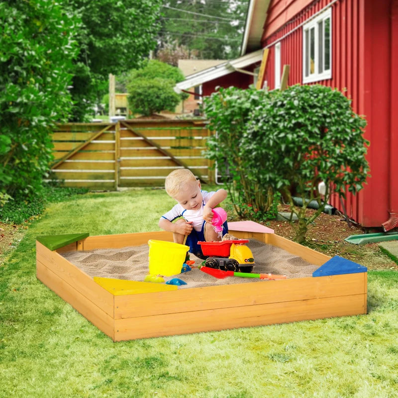 Kids wooden sand pit with beige sand, colorful corner seats, and child playing