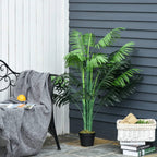 Artificial palm tree in black pot with green fronds, outdoors patio placement