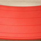 Red textured top surface of the curved kids wobble board