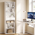 White tall narrow bookshelf with open cubbies and drawer beside a desk
