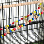 Bird cage interior with colorful bead ropes and wooden perch swing on bars