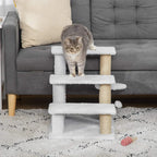 White 3-level cat climbing tower with plush steps, sisal posts, and a toy ball on floor