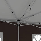 Interior support frame of pop-up gazebo with white crossbeams and central pole