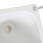 Close-up of white wash basin drain with strainer on portable camping sink
