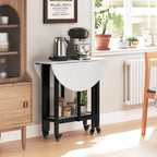 Folding dining table with drop leaf, open shelf, and caster wheels in a white marble finish
