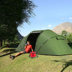 Dark green tunnel camping tent with open doorway and front awning over entry