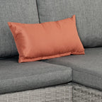 Orange throw pillow on grey outdoor sofa with thick seat cushion