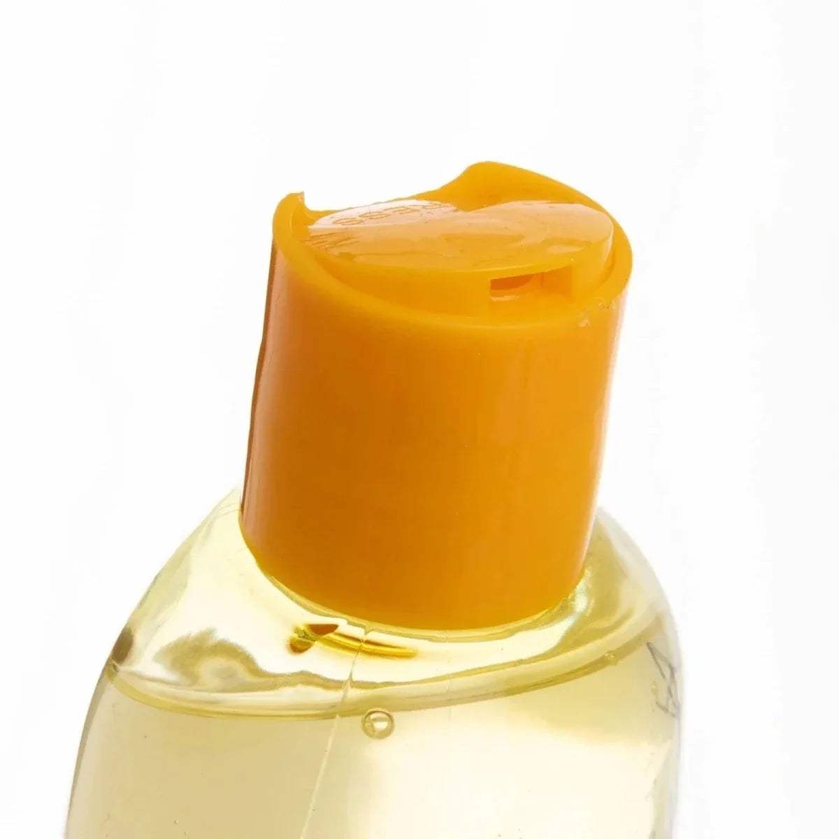 Orange flip-top cap close-up on baby shampoo bottle