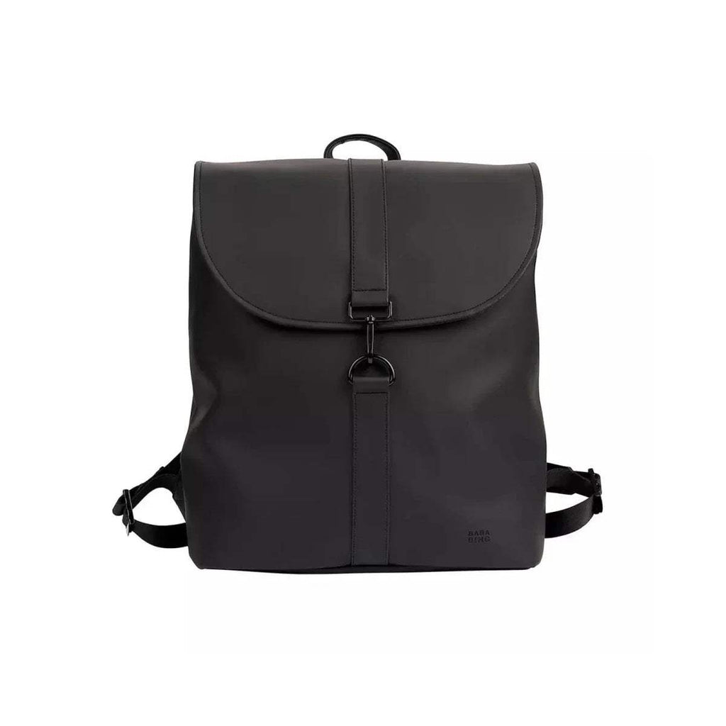Black changing backpack front view with flap pocket, front buckle, and top handle