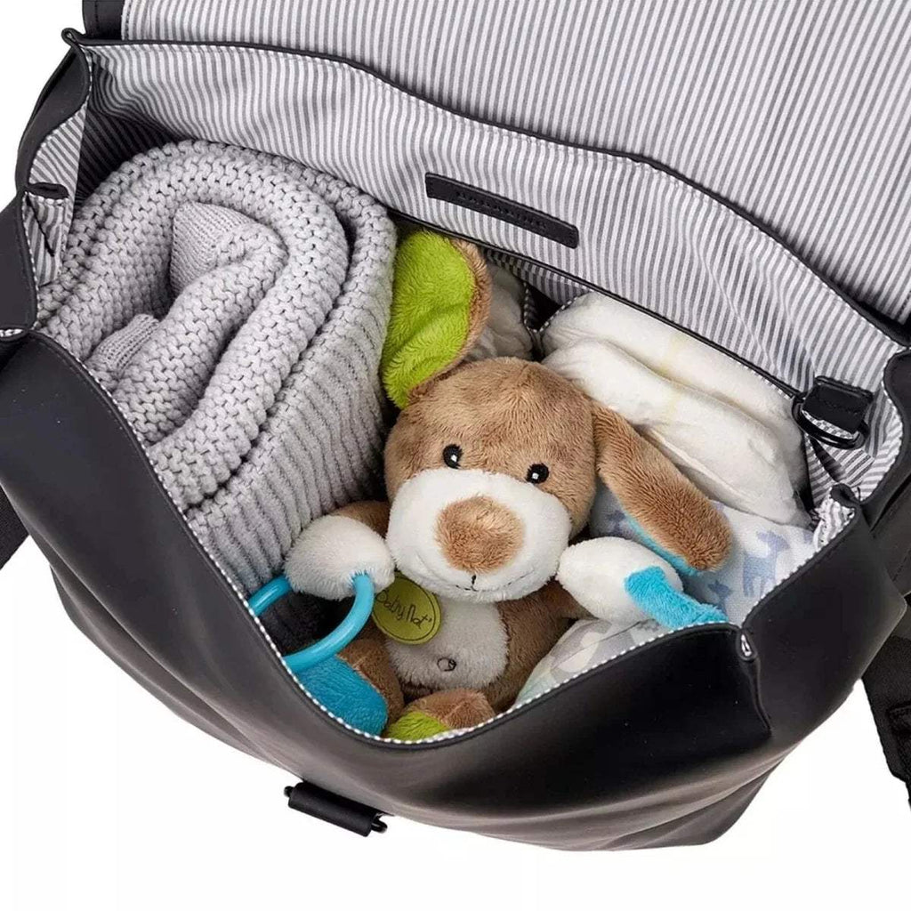 Open black backpack with padded interior, plush toys, and striped lining