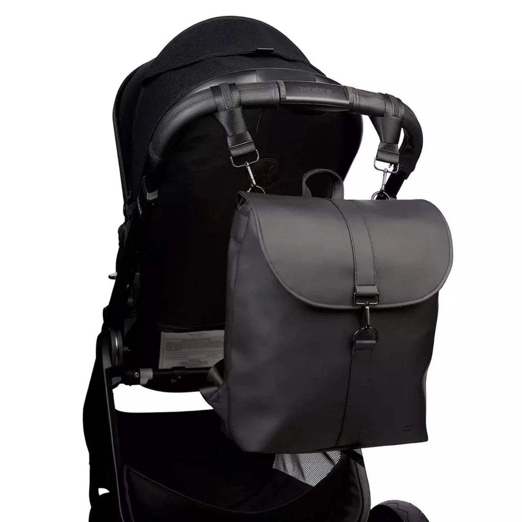 Black changing backpack with front flap, shoulder straps, and stroller attachment straps