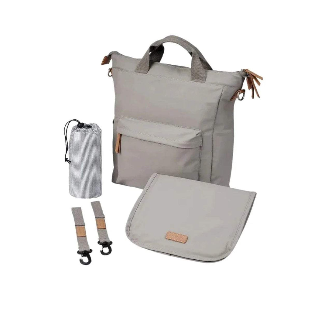 Beige changing bag with front pocket, top handles, and crossbody strap