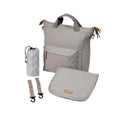 Beige changing bag with front pocket, top handles, and crossbody strap