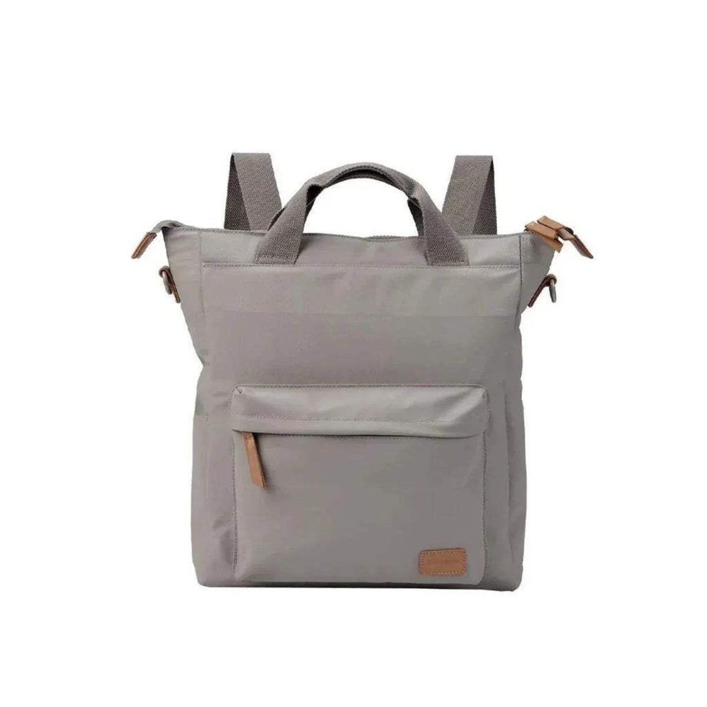 Light beige changing bag with two straps, front pocket, and small leather patch