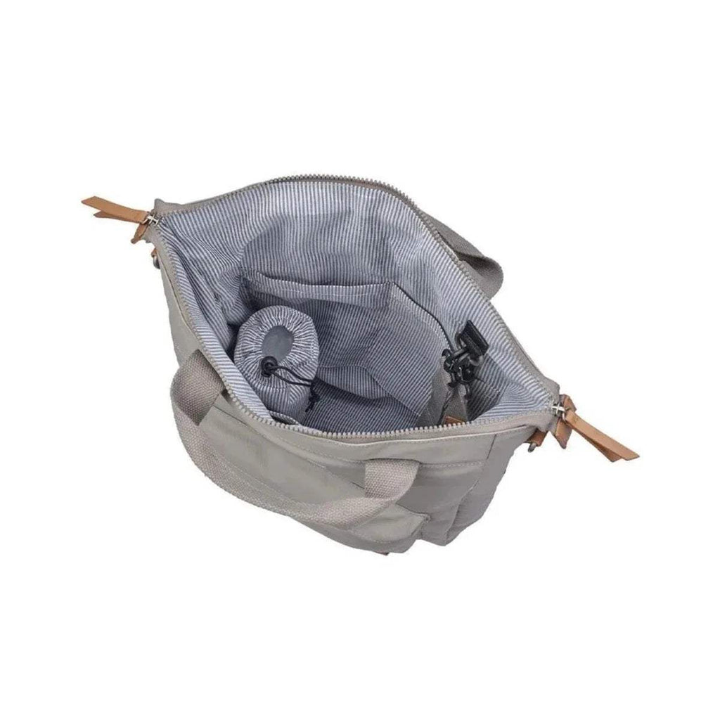 Beige changing bag open to show striped interior organizer and zipper pocket