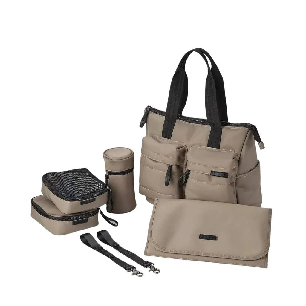 Mink changing bag with black handles, front pockets, and matching accessory pouches