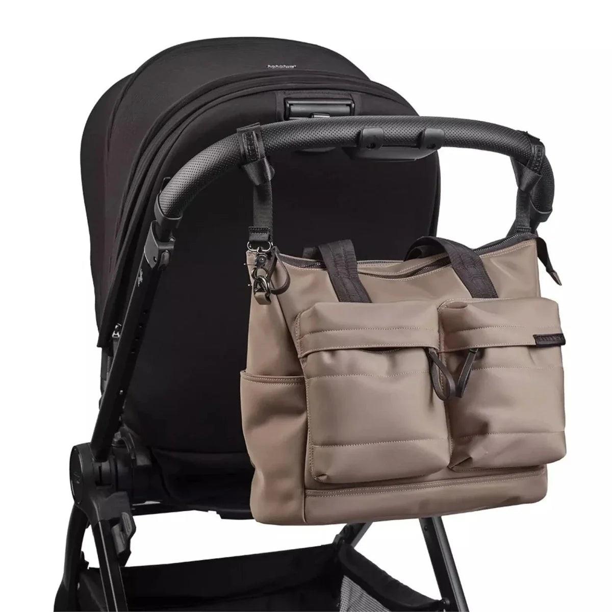 Mink changing bag attached to stroller with front organizer pockets and black strap
