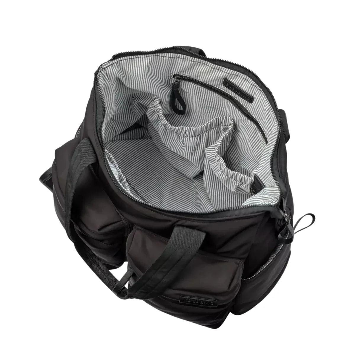 Black changing bag interior view with striped lining and zip pockets