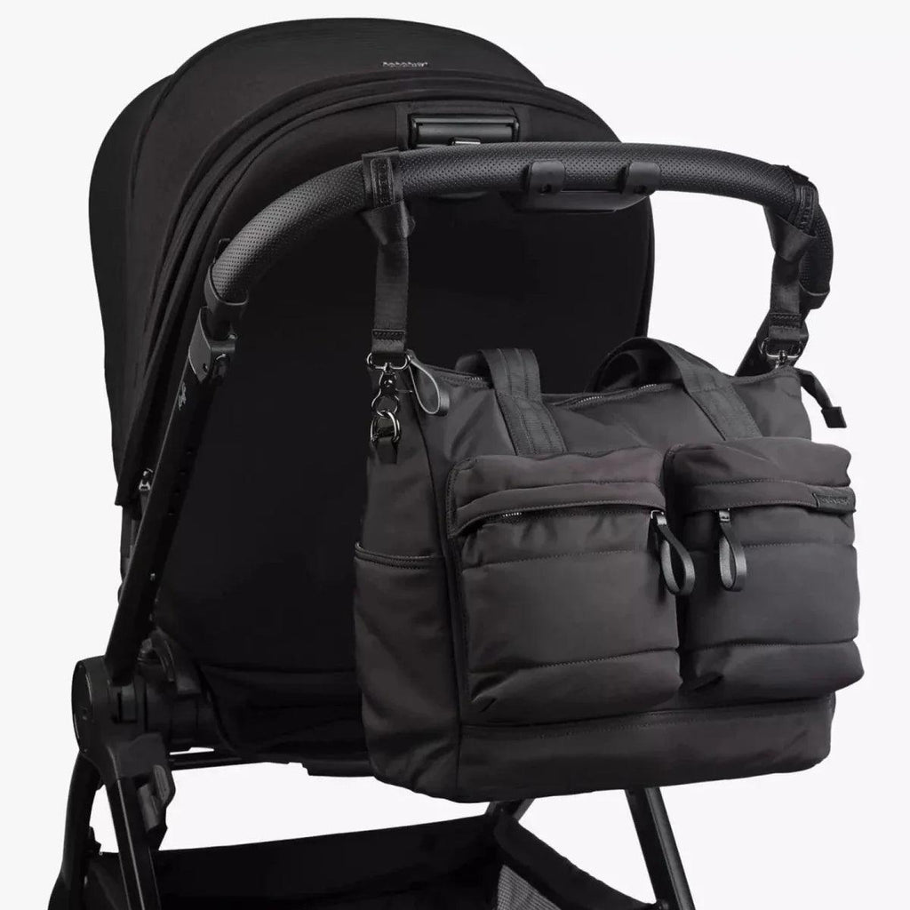 Black changing bag attached to stroller with front organizer pouch