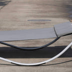 Grey rocking lounger seat with curved metal runners and stitched fabric surface