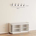White hallway storage bench with open shelving and wall coat hooks