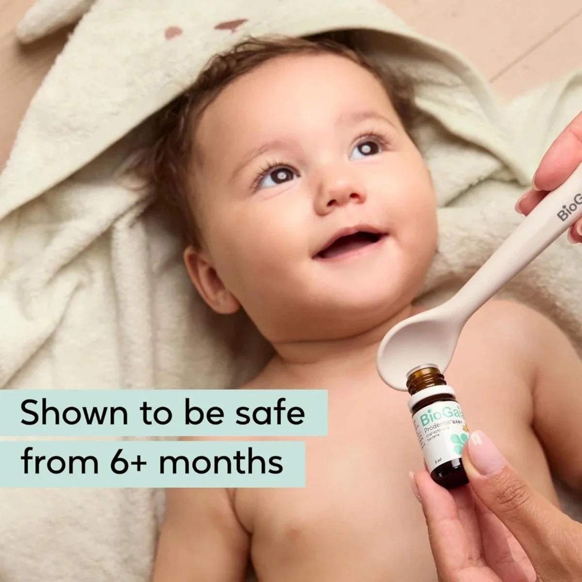 Baby receiving probiotic drops from dropper held near bottle, 5 ml