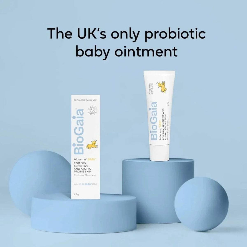 Baby ointment tube with matching box on blue pedestal
