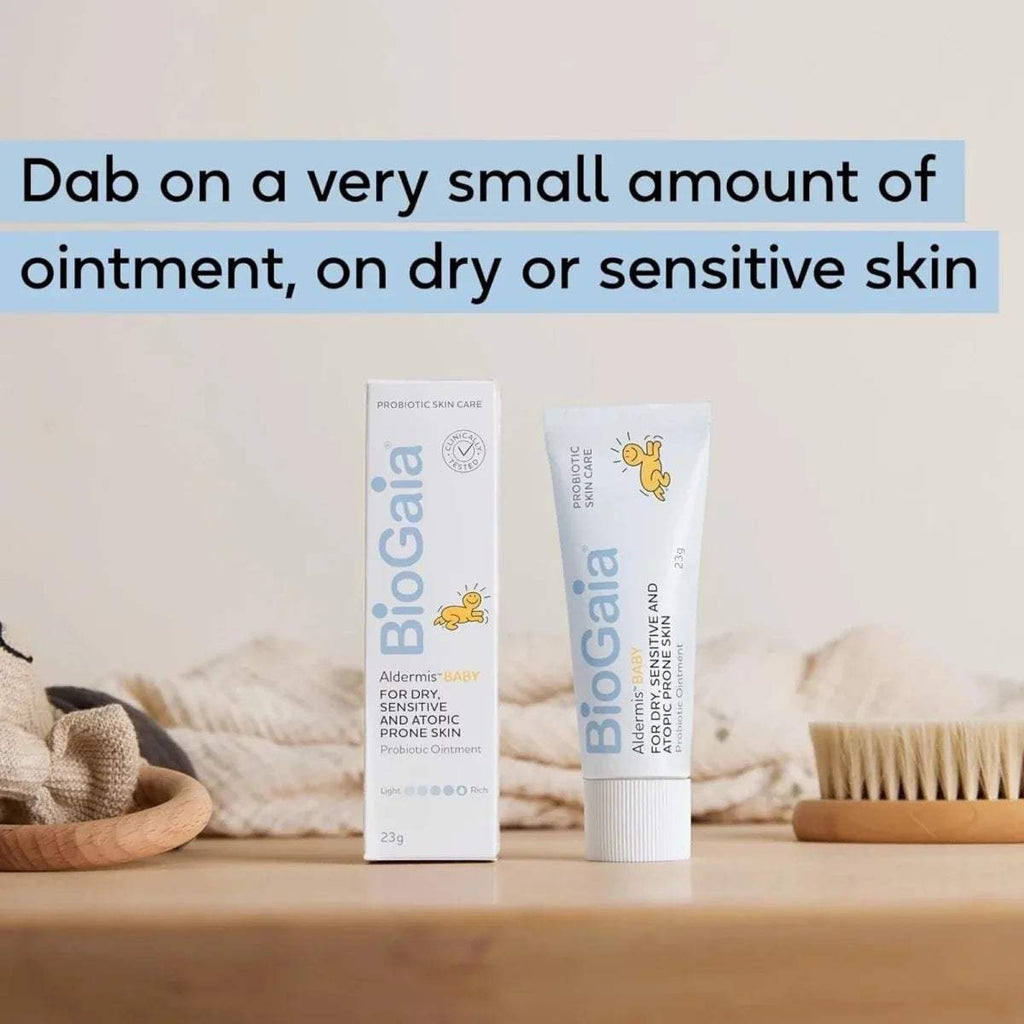 Baby ointment tube and carton set on light wooden surface