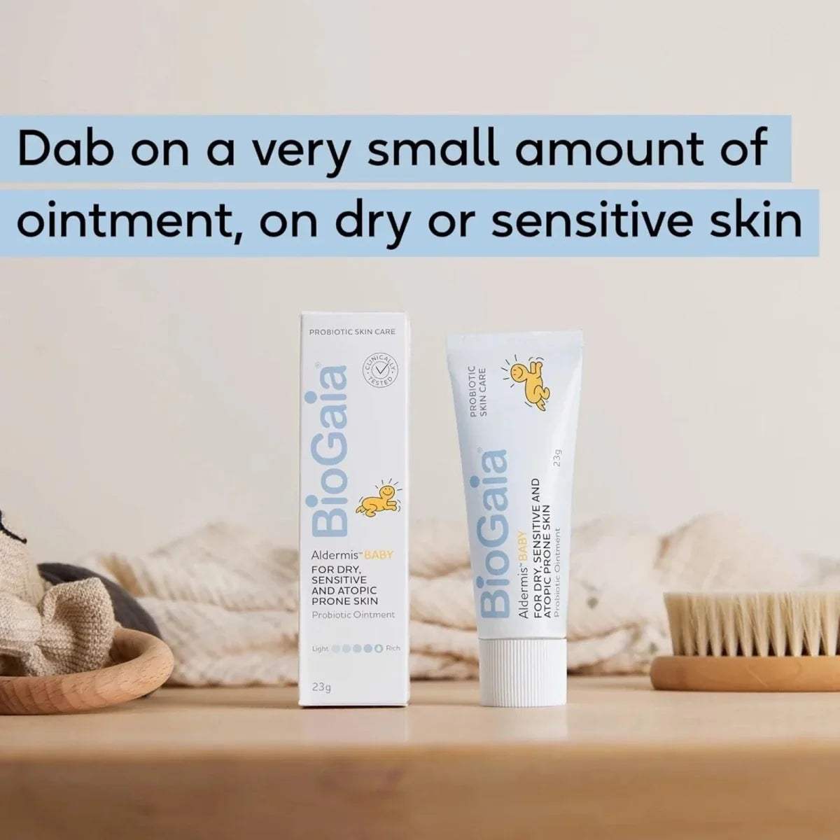 Baby ointment tube and carton set on light wooden surface