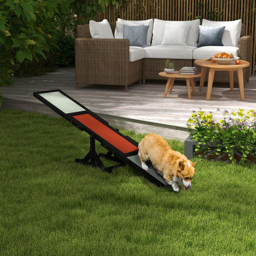 Outdoor black dog seesaw with orange center and light anti-slip surface, used by dog
