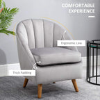 Grey velvet accent chair with thick padding, curved arms, and angled wooden legs