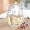 Floral stemless glass tumbler in clear glass with colorful wildflower print