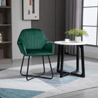 Green accent chair with tufted back and armrests on black metal sled base