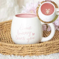 White ceramic mug with pink “Some bunny loves you” text and bunny peeking from top