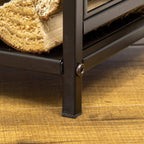 Black steel log rack leg detail with round hardware, standing on floor