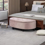 Pink tufted storage ottoman bench at bed end with black legs