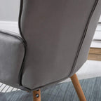 Grey wingback armchair side view with padded back and curved arm