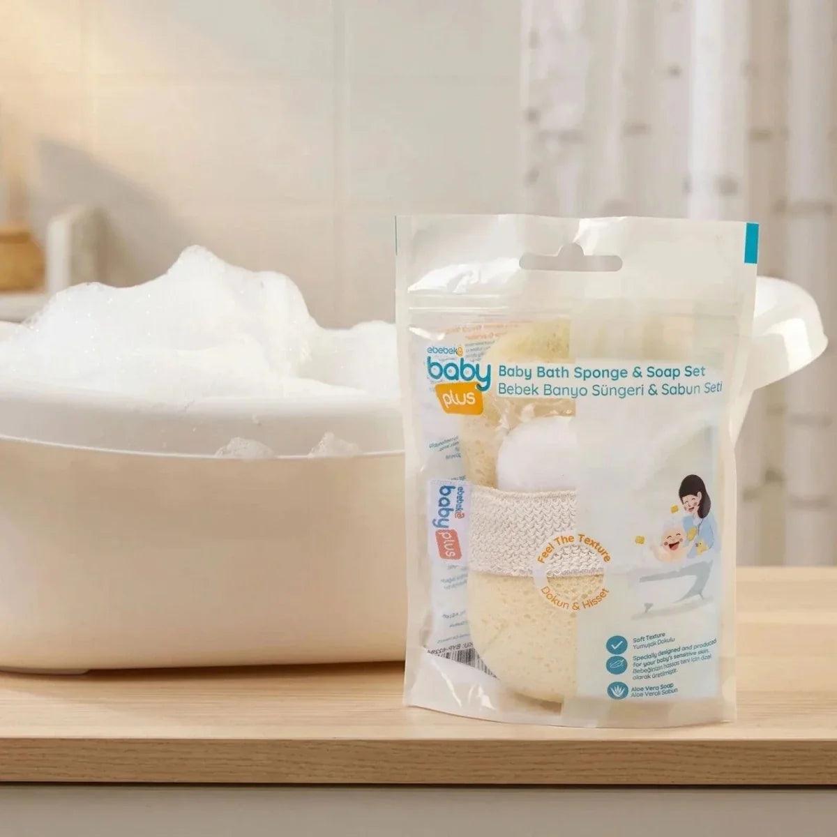 Baby bath sponge and soap set with retail pouch, sponge and soap bar on bath ledge