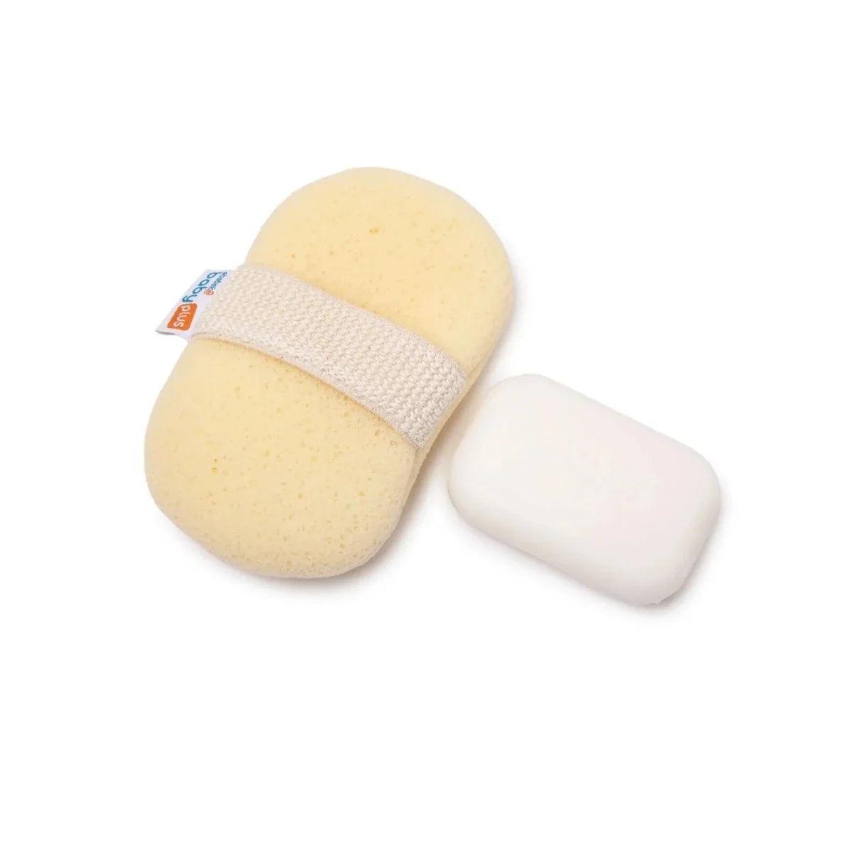 Bath sponge with textured strap holding a white soap bar beside it