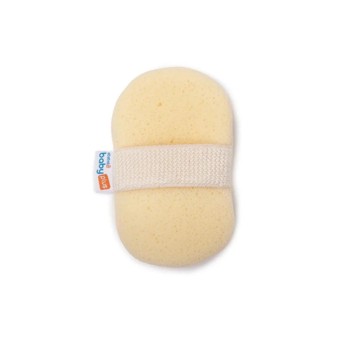 Round light beige bath sponge with white textured strap and blue tag